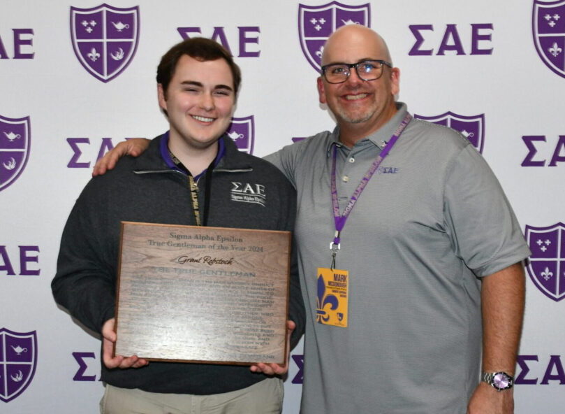 SAE brother receiving an award