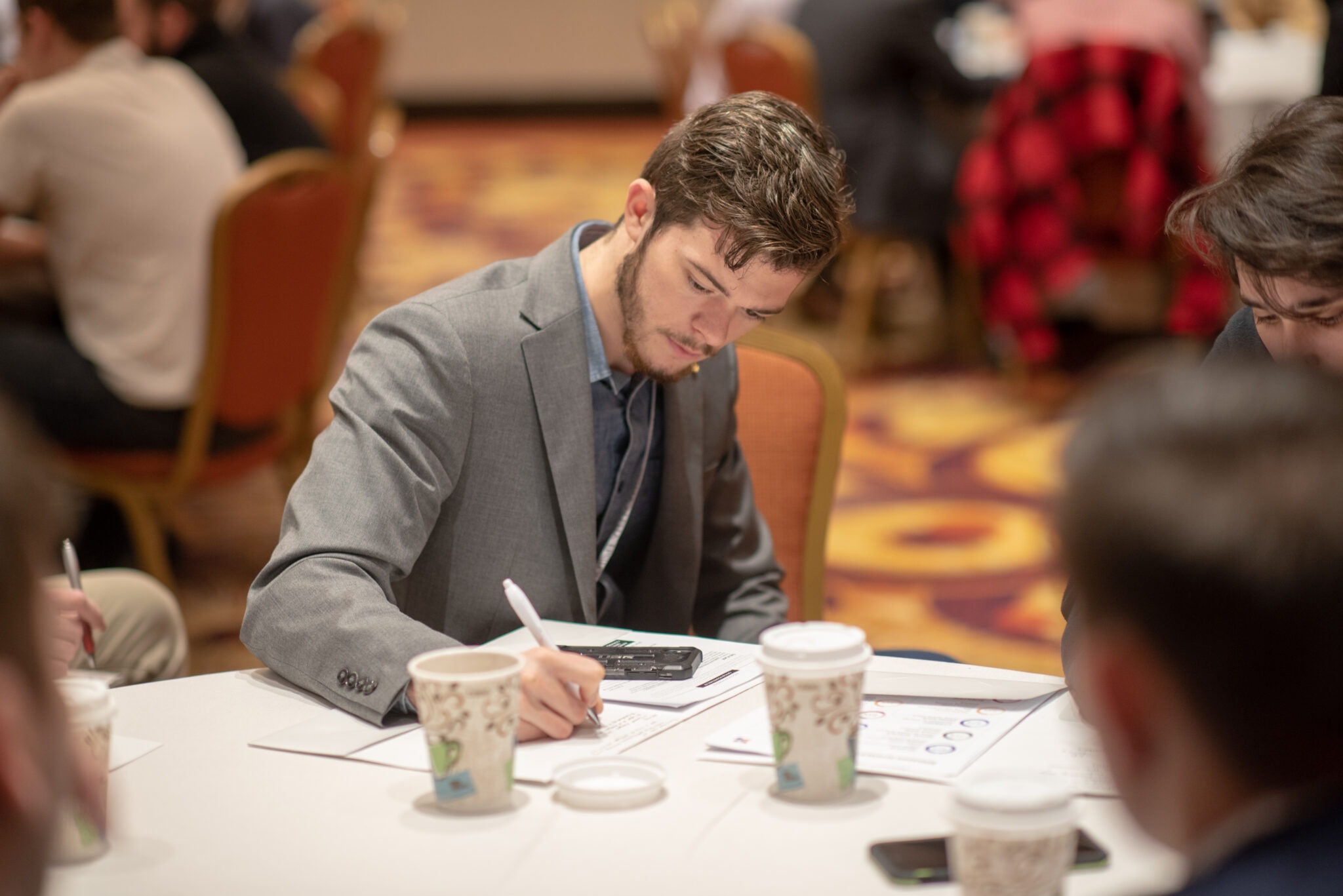student writing at a table