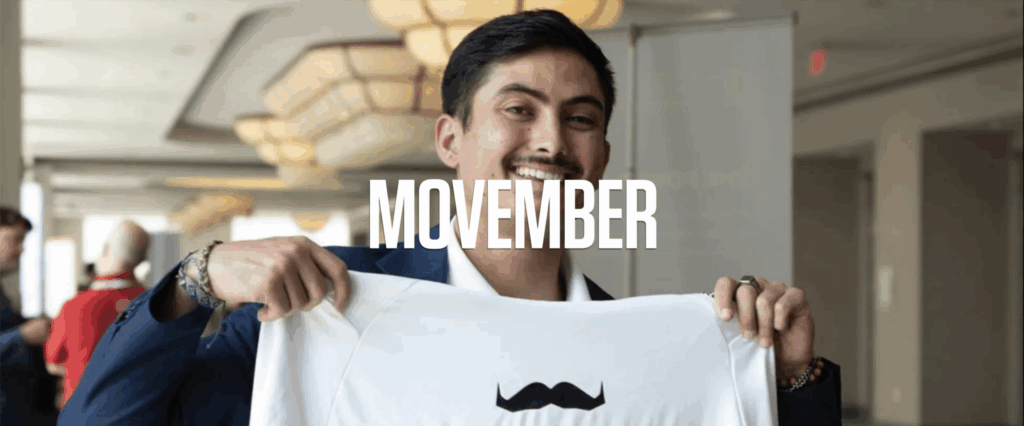 SAE holding a Movember t-shirt