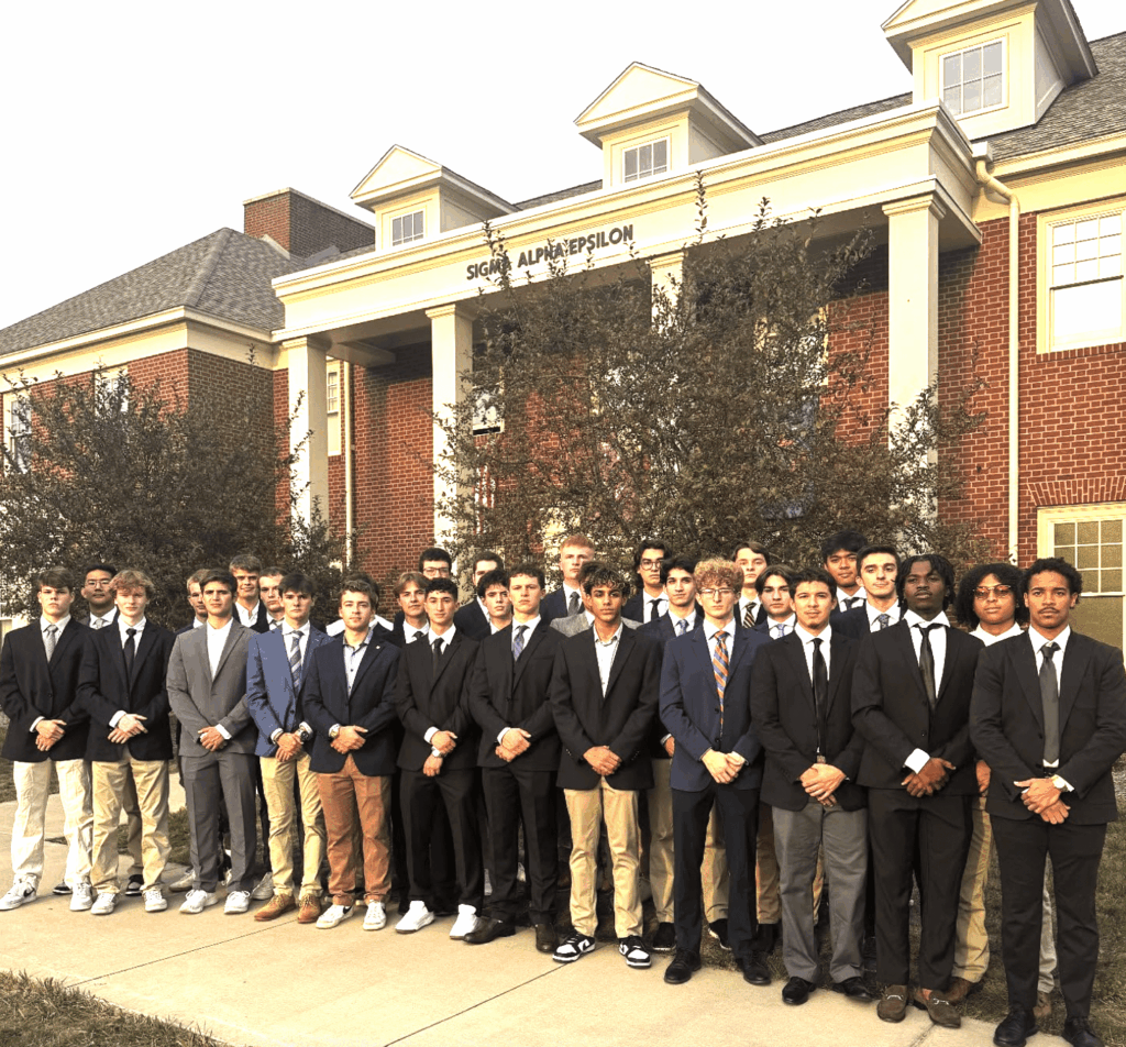 group photo of SAE brothers outside frat house