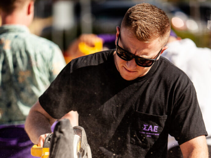 SAE brother volunteering with construction
