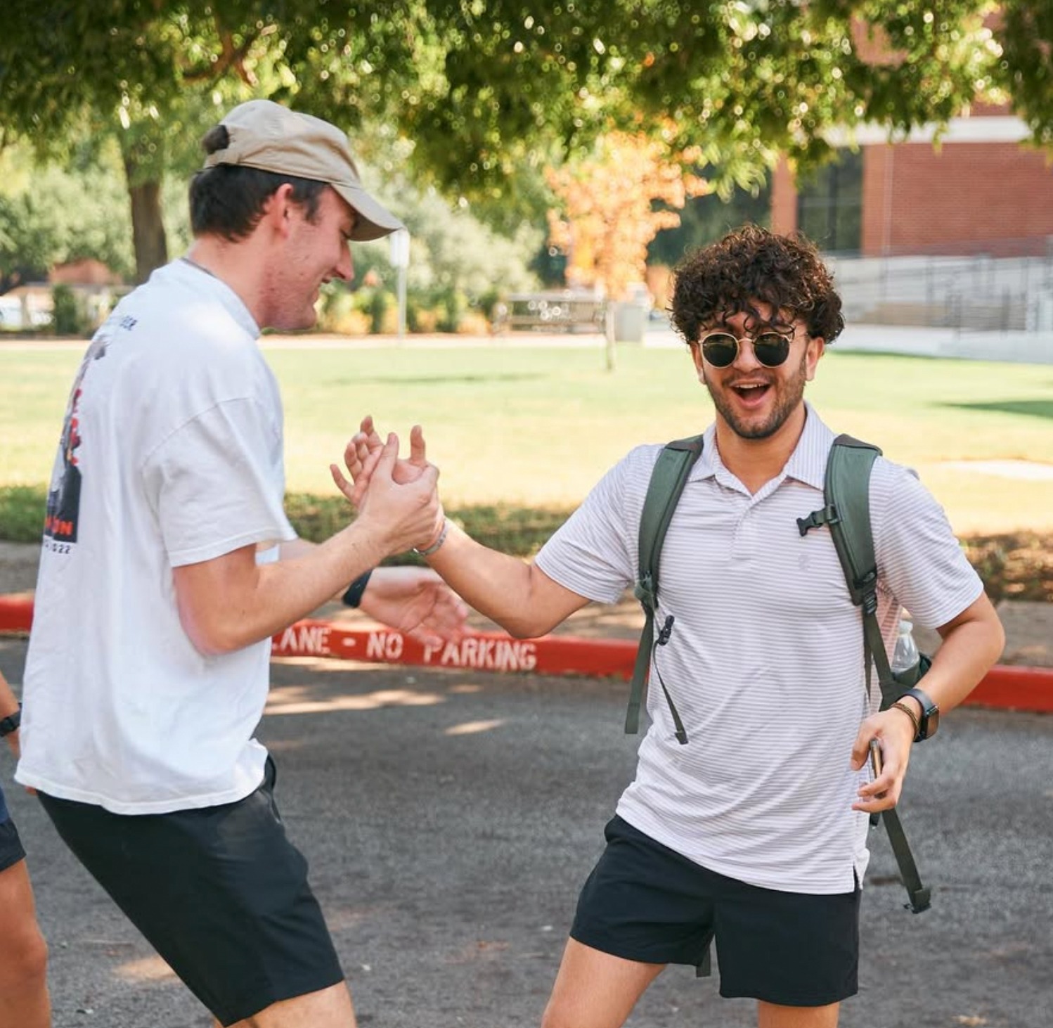 two SAE brothers slapping hands