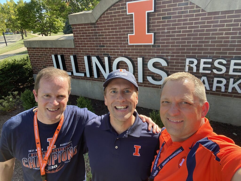 3 SAE brothers outside of Illinois sign