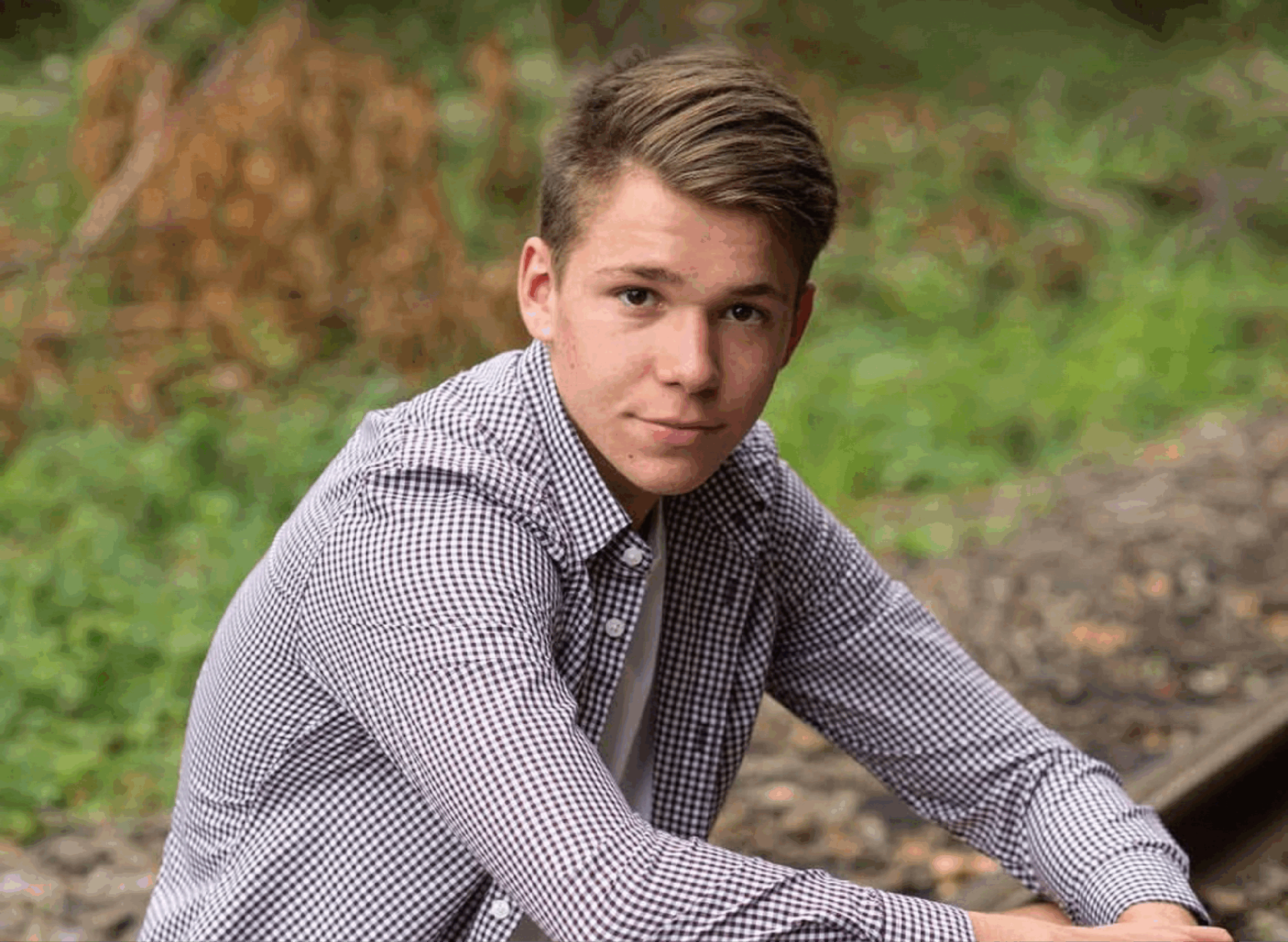 SAE scholarship recipient sitting outside